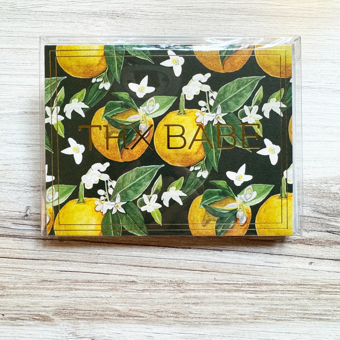 Set of 6 folded full color gold foil stamped cards with dark green background and watercolor painted orange blossom flowers and oranges in foreground, blank inside. 6 luxe gray envelopes.