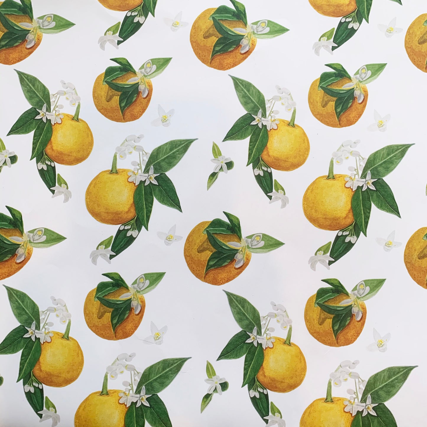 A close up of the Orange Blossom pattern! Vibrant yellows and oranges with green leaves and white orange blossom flowers